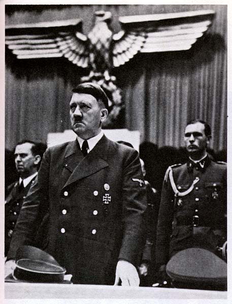 Hitler standing under the Eagle of the Third Reich. 